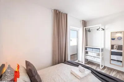 a bedroom with a bed and a large mirror at BeGuest Oceanic Rainbow Apt in Albufeira