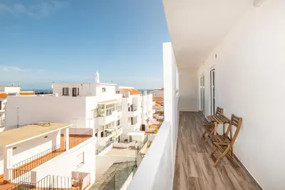 a balcony with chairs and a view of the ocean at BeGuest Oceanic Rainbow Apt in Albufeira