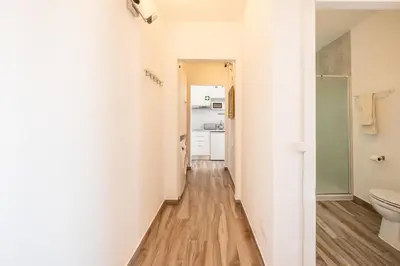 a corridor of a bathroom with a toilet at BeGuest Oceanic Rainbow Apt in Albufeira