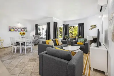 a living room with couches and a dining room at Vista Portuguesa by OCvillas in Albufeira