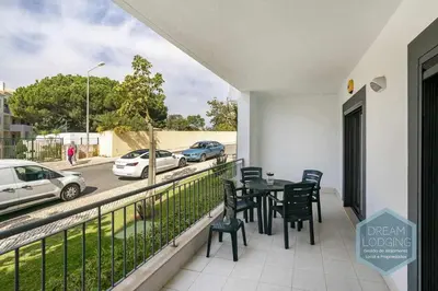 a balcony with a table and chairs and a street at Vista das Ondas 02B - Dream Lodging in Albufeira