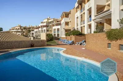 a swimming pool in front of some apartment buildings at Oceanus Jardim - Dream Lodging in Albufeira
