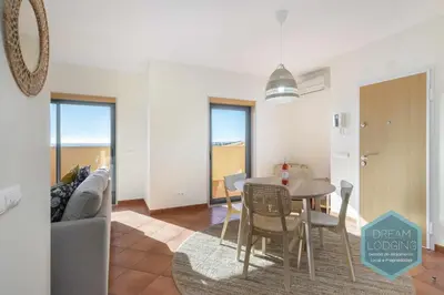 a living room with a table and a couch at Oceanus Jardim - Dream Lodging in Albufeira