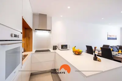 a bedroom with a couch and a tv on a wall at #087 T1 Vale Mangude 308 by Home Holidays in Albufeira