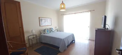 a bedroom with a bed and a tv and a window at Albufeira Apartment Pool & Tennis in Albufeira