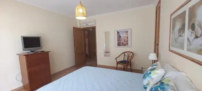 a bedroom with a bed and a tv on a dresser at Albufeira Apartment Pool & Tennis in Albufeira