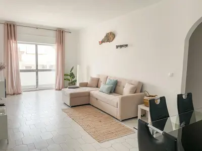 a living room with a couch and a table at Sunny House Albufeira in Albufeira