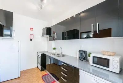 a kitchen with a counter and a microwave oven at Sunny House Albufeira in Albufeira