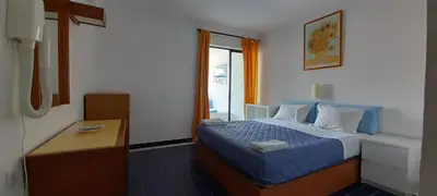 a hotel room with a bed and a window at CASA ROMAN Poente da Aldeia in Albufeira