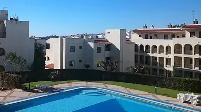 a swimming pool in front of some buildings at CASA ROMAN Poente da Aldeia in Albufeira