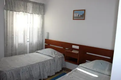 a room with two twin beds and a window at Dom Fernando I in Loulé