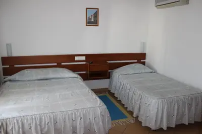 two twin beds in a room with a wall at Dom Fernando I in Loulé
