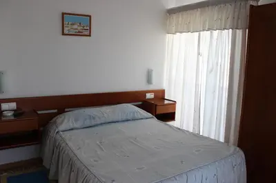 a bedroom with a bed and a window at Dom Fernando I in Loulé