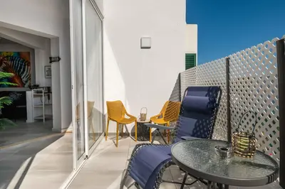 a patio with a table and chairs on a balcony at Salgados 2-Bedroom Apartment - 900m from the Beach - Wifi in Guia
