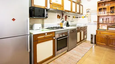 a kitchen with a refrigerator and a stove top oven at Apartamento Pateo - Algarve - BY BEDZY in Albufeira