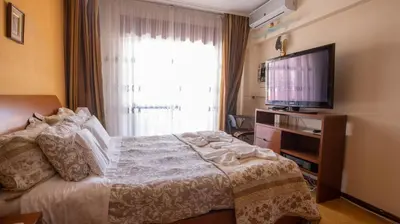 a bedroom with a bed and a flat screen tv at Apartamento Pateo - Algarve - BY BEDZY in Albufeira