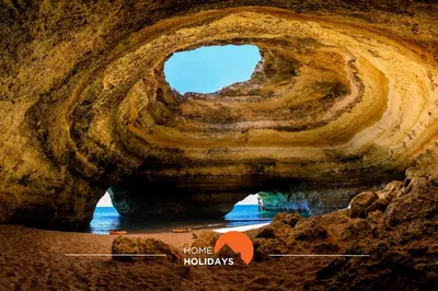 a rock cave with a hole in the water at #098 Casa Antonieta 3 by Home Holidays in Albufeira