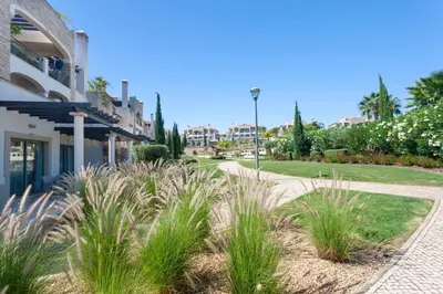 a walkway in front of a building with plants at Vilamoura Pine Hills Villa in Vilamoura