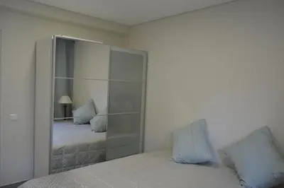 a bedroom with a large mirror next to a bed at Marina Plaza, Vilamoura in Vilamoura