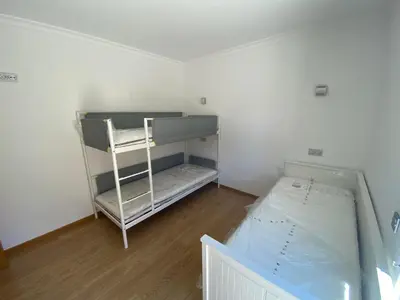 a small room with a bunk bed and a ladder at Janelas do Oceano - Casa de Ferias T3 Vilamoura in Vilamoura
