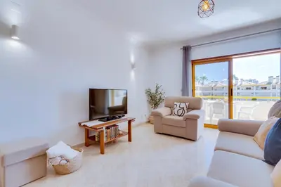 a kitchen with a table with a bowl of fruit on it at AL - Apartamento Atlântida Mar in Quarteira