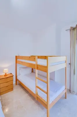a bedroom with a white bed and two night stands at AL - Apartamento Atlântida Mar in Quarteira
