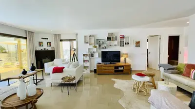 a living room with white furniture and a tv at Praia by Check-in Portugal in Albufeira