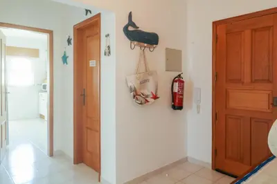 a room with a door and a bag on the wall at Apartamento Sea Shell in Albufeira