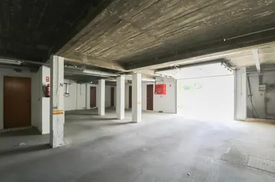 an empty room with a large door in a building at Apartamento Sea Shell in Albufeira