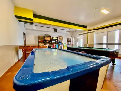 a pool table in the middle of a room at Fresh and cosy appt with Pool, Fiber, LargeTV, Gaming Room in Albufeira