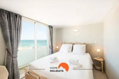 a bedroom with a bed with a large window at #086 Fish House by Home Holidays in Albufeira