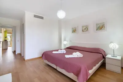 a bedroom with a bed with two towels on it at Albufeira Townhouse beach in Albufeira