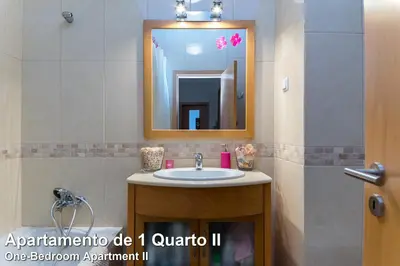 a bathroom with a sink and a mirror at Akisol Albufeira Rainbow in Albufeira