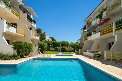 a swimming pool in front of a building at AL - Apartamento Sol Nascente 1 Top Floor in Quarteira