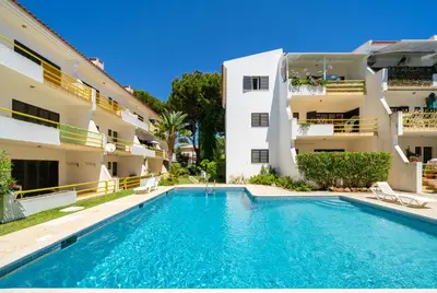 an apartment with a swimming pool in front of a building at AL - Apartamento Sol Nascente 1 Top Floor in Quarteira