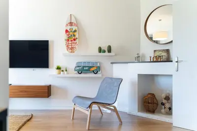 a living room with a blue chair in front of a fireplace at AL - Apartamento Sol Nascente 1 Top Floor in Quarteira