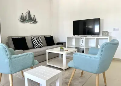 a living room with a couch and a tv at Nutmeg - 50mtrs to beach - by HD PROPERTIES in Quarteira