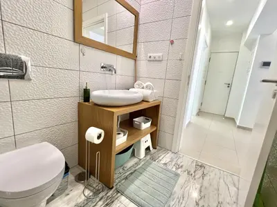 a bathroom with a sink and a toilet at Nutmeg - 50mtrs to beach - by HD PROPERTIES in Quarteira