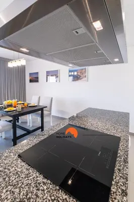 a laptop on a kitchen counter in a room at #090 Correeira by Home Holidays in Albufeira