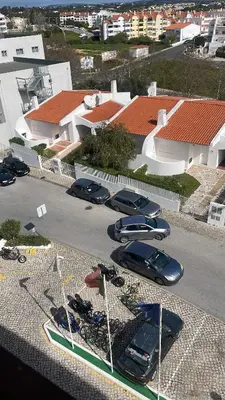 a group of cars parked in a parking lot at Apartamento Maria do Céu Villa Magna in Albufeira