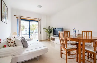 a living room with a couch and a table at Quarteira beach house in Quarteira