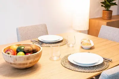 a wooden table with a bowl of fruit on it at CATCH - Vilamoura in Vilamoura