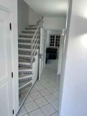 a hallway with a staircase in a house at Relaxing 2 Bedroom House 5 minutes away from Vilamoura Marina in Quarteira