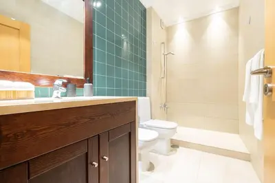 a bathroom with a toilet and a sink and a shower at Vilamoura Hideaway - Golf, Pool & Beach in Vilamoura