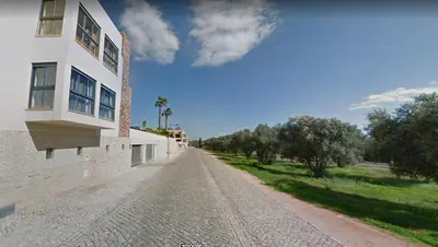 an empty dirt road next to a building at Vilamoura Hideaway - Golf, Pool & Beach in Vilamoura