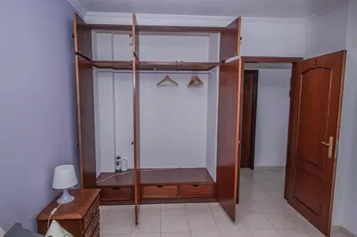 a room with a shower with a bench in it at Charming Private Rooms in an Apartment A2 Penha - Faro in Faro