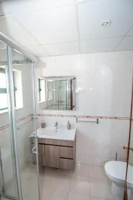 a bathroom with a sink and a shower and a toilet at Charming Private Rooms in an Apartment A2 Penha - Faro in Faro