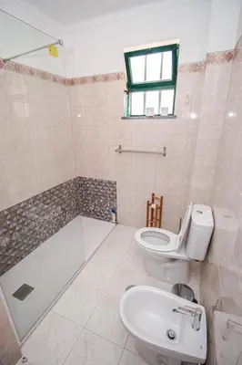 a bathroom with a toilet and a tub and a sink at Charming Private Rooms in an Apartment A1 Penha - Faro in Faro