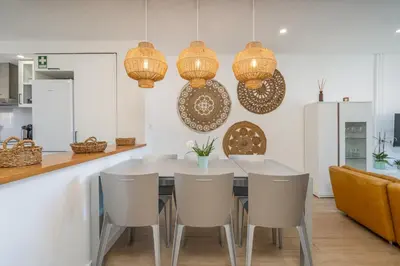 a kitchen with a white table and chairs at Beco do Sol, Albufeira in Albufeira