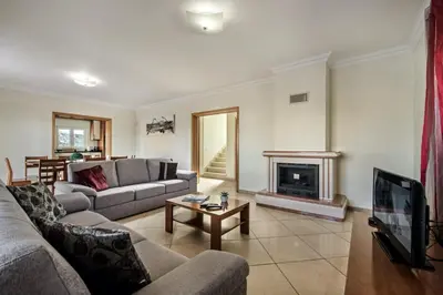 a living room with a couch and a fireplace at Villa Das Oliveiras amazing location walk to Marina restaurants beach in Albufeira